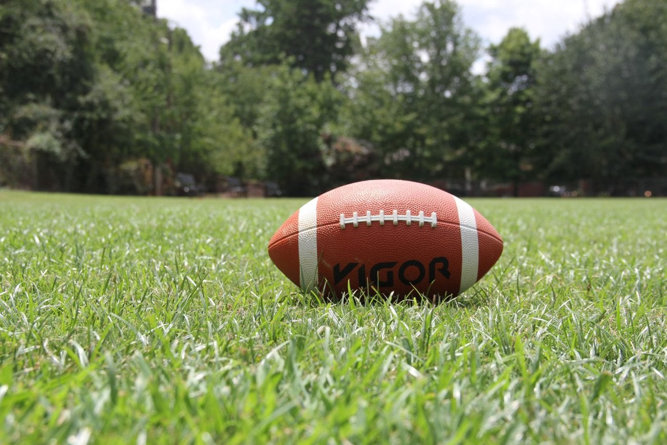 american football on grass field