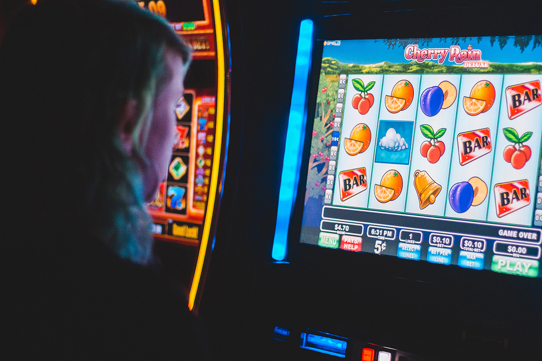 person playing a slot game