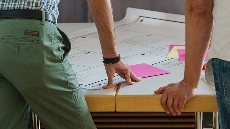 two people at a drawing board