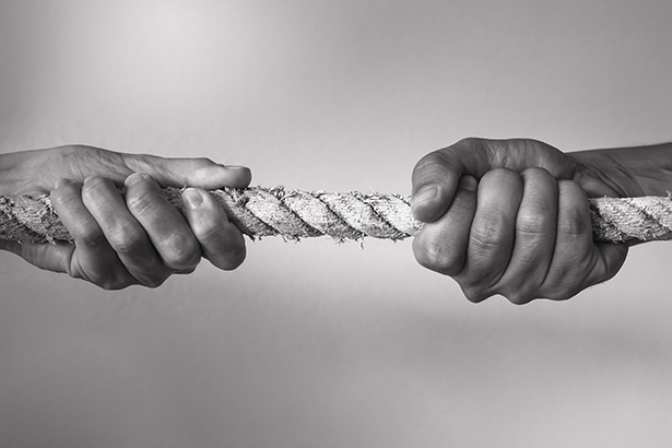 Hands pulling rope playing tug of war